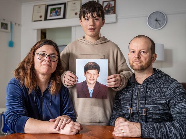 Bochara fatal crash where four people were killed in a car accident. Hamilton. The Elmes family hold a photo of Joshua Elmes (15) who died in the car accident. (L-R) Mother Lee Ann (41), brother Aaron (12) and father Matthew (46). Picture: Jake Nowakowski