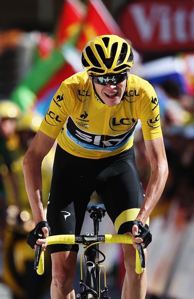 Chris Froome of Great Britain and Team Sky crosses the finish line at the end of the gruelling climb up L'Alpe d'Huez in 2015.