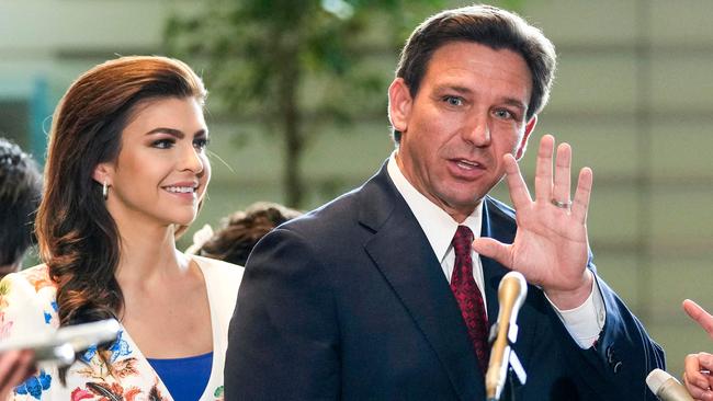 Florida Governor Ron DeSantis waves to journalists as his wife Casey looks on. Picture: AFP.