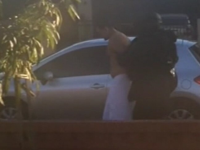 Screen Grabs from Nine News Sydney showing Mahmoud Khayat being led out of a Lakemba property in towel with police. Picture: Nine News Sydney