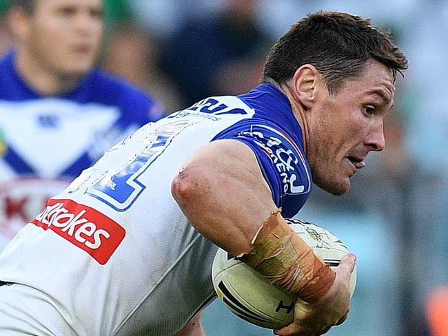 Josh Jackson of the Bulldogs is tackled by Campbell Graham of the Rabbitohs during the Round 18 NRL match between the Canterbury-Bankstown Bulldogs and the South Sydney Rabbitohs at ANZ Stadium in Sydney, Saturday, July 14, 2018. (AAP Image/Dan Himbrechts) NO ARCHIVING, EDITORIAL USE ONLY