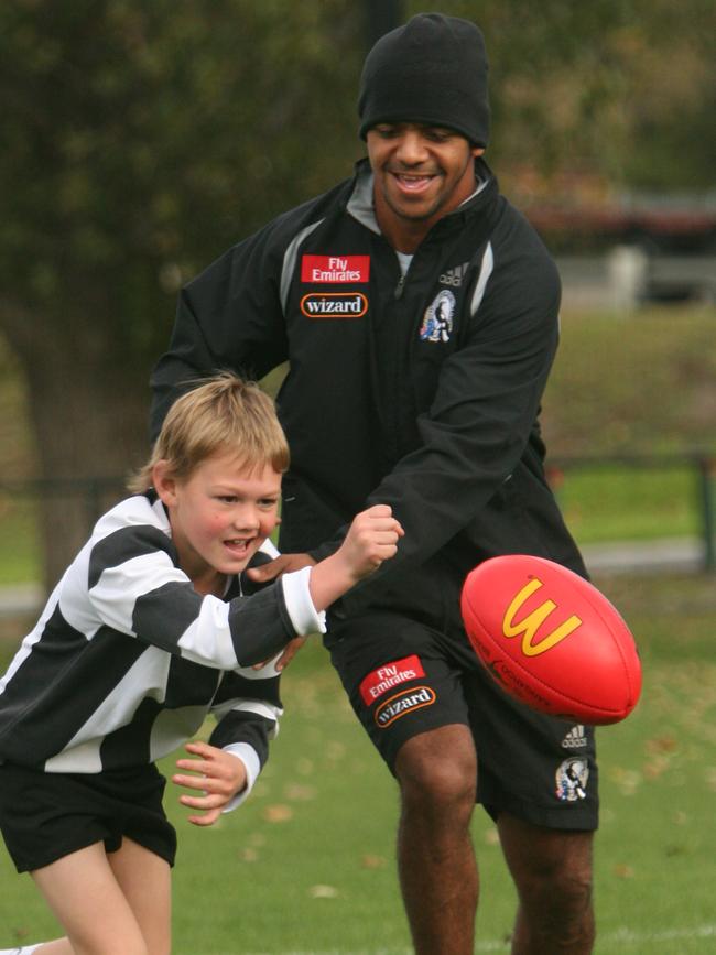 Colac Under 14 football team train with Collingwood FC. Lochie Rosevear, 9, of Colac, races Leon Davis to the ball.