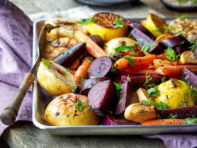 Roasted fruits and vegetables on wooden table