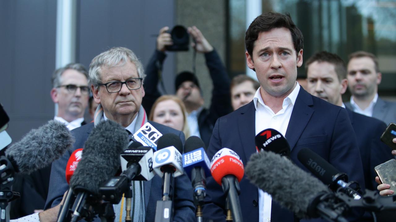 Nick McKenzie, right, flanked by Chris Masters speaks to the press outside the Federal Court in Sydney. Picture: Christian Gilles