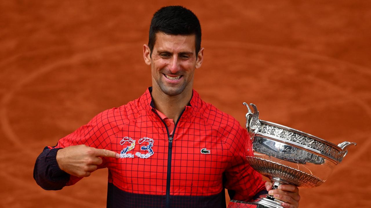 Novak Djokovic celebrates with the winners trophy. (Photo by Clive Mason/Getty Images)