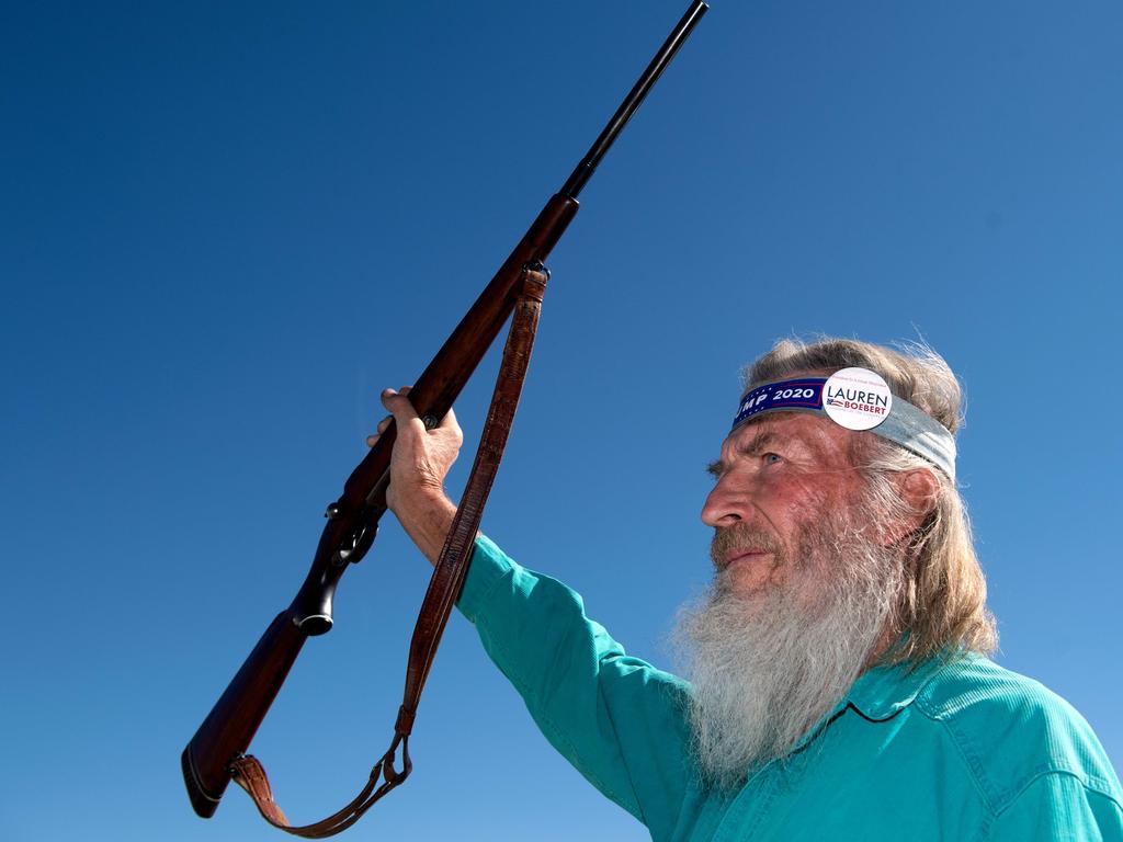 Bob Nerinx of Delta, Colorado, holds up his rifle while attending a campaign rally for Lauren Boebert, the Republican candidate for the US House of Representatives. Picture: Jason Connolly / AFP