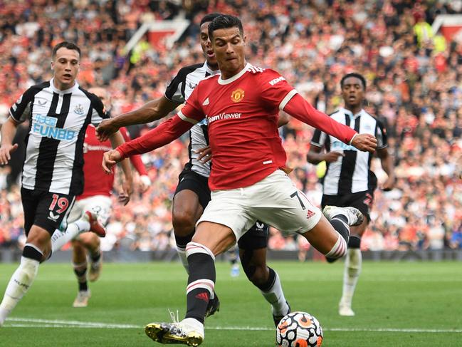 TOPSHOT - Manchester United's Portuguese striker Cristiano Ronaldo prepares to shoot to score their second goal during the English Premier League football match between Manchester United and Newcastle at Old Trafford in Manchester, north west England, on September 11, 2021. (Photo by Oli SCARFF / AFP) / RESTRICTED TO EDITORIAL USE. No use with unauthorized audio, video, data, fixture lists, club/league logos or 'live' services. Online in-match use limited to 120 images. An additional 40 images may be used in extra time. No video emulation. Social media in-match use limited to 120 images. An additional 40 images may be used in extra time. No use in betting publications, games or single club/league/player publications. /