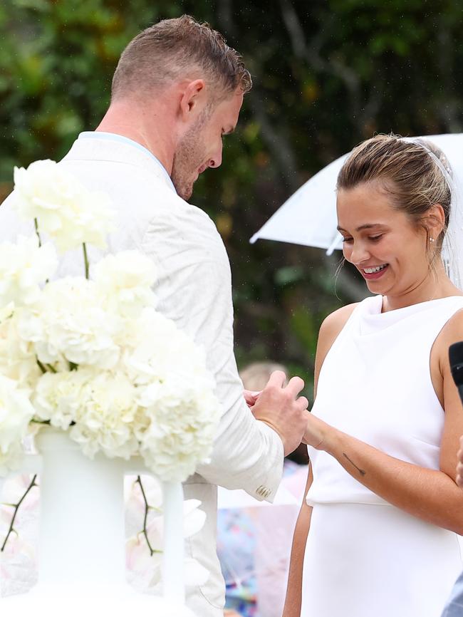 The couple exchange rings.