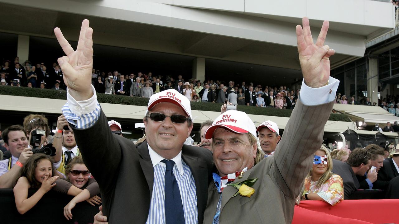 Australian winning owner Tony Santic, right, and winning trainer Lee Freedman hold up three fingers to demonstrate winning 3 Melbourne Cup's with Makybe Diva in the Melbourne Cup at Flemington Racecourse, Melbourne Australia. (AP Photo/ Tony Feder)