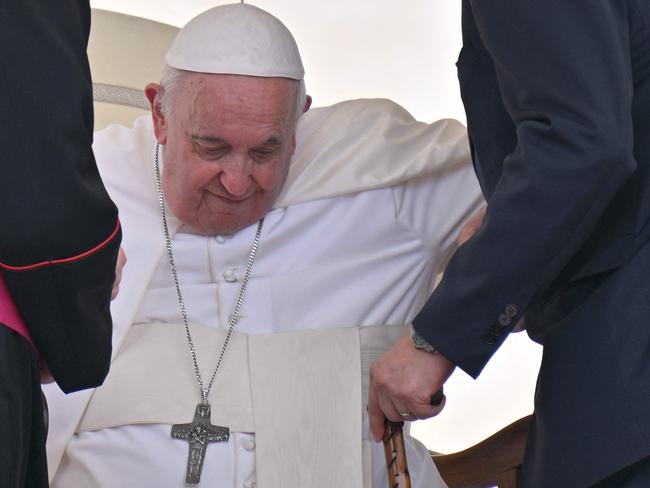 Pope Francis being helped to his feet at the end of the weekly general audience at St. Peter's square in The Vatican. Picture: AFP