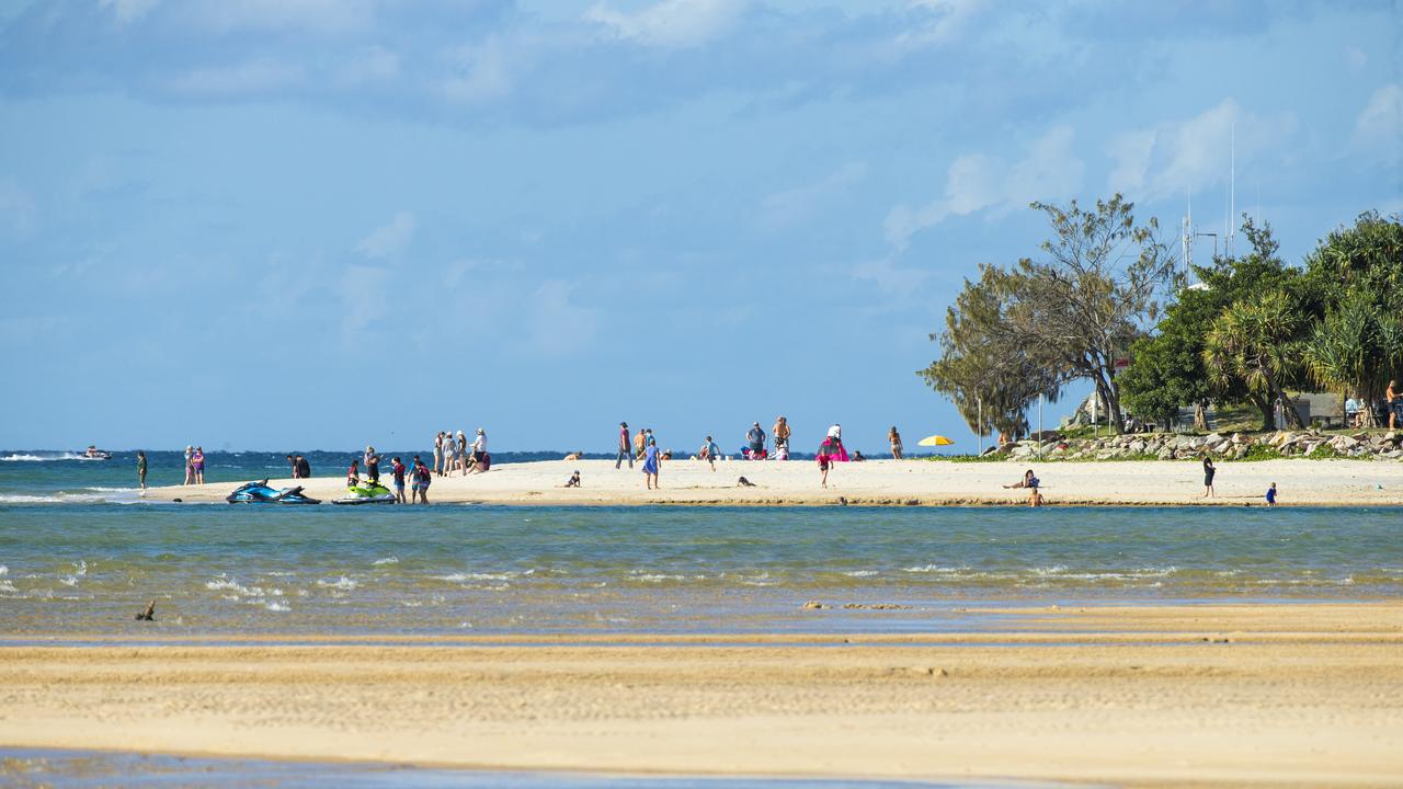 Holiday makers enjoying the beach at Noosa Rivermouth. Photo Lachie Millard