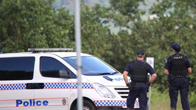 Officers at the Holloways Beach roundabout on the Captain Cook Highway. Police have been attempting to communicate with the armed man. Picture: PETER CARRUTHERS