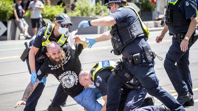 A protester is arrested at State Parliament in Melbourne on Tuesday. Picture: Jake Nowakowski