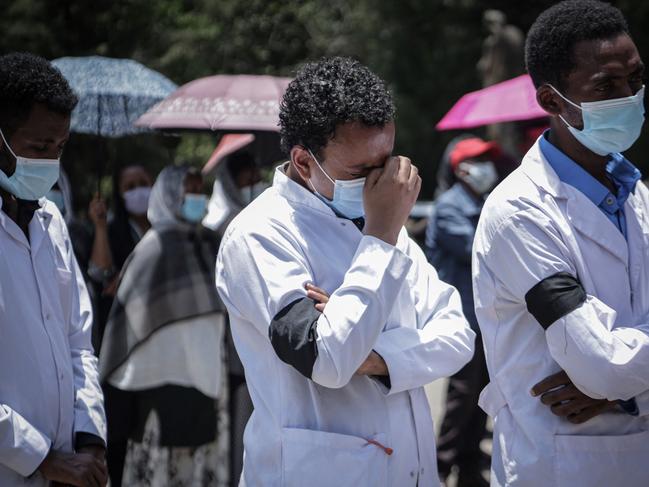 Medical workers mourn the death of 59-year-old Ethiopian medical doctor Aynaelm Abrha who worked at a hospital to treat the patients infected by Covid-19 since the beginning of the pandemic and died by Covid-19 during their joint funeral for two doctors at Holy Trinity Cathedral church in Addis Ababa, Ethiopia, on April 10, 2021. - The novel coronavirus has registered 225516 cases and 3111 Deaths in Ethiopia since the pandemic began. On March 27, Ethiopiaâs Ministry of Health announced a partial lockdown in Addis Ababa after numbers of deaths spiked. (Photo by Amanuel SILESHI / AFP)