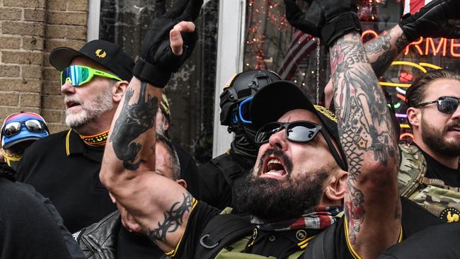 Members of the Proud Boys gather outside of Harry's bar during a protest in Washington in December 2020. Picture: Stephanie Keith/Getty Images