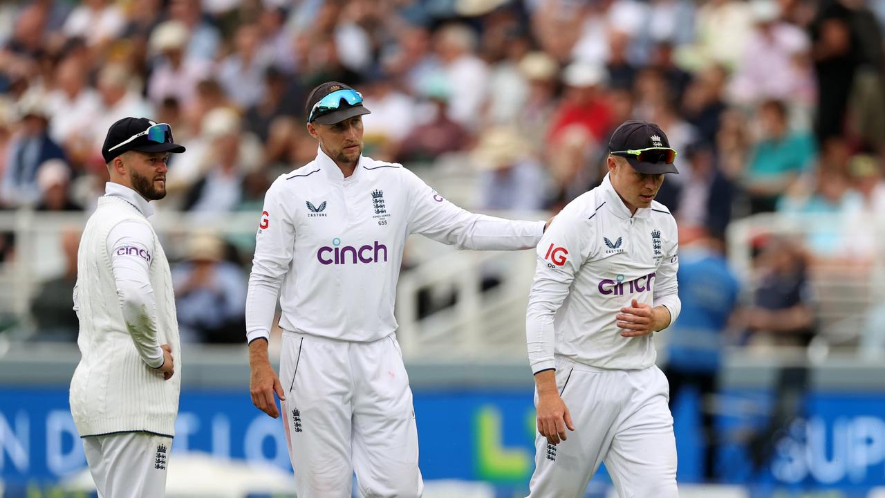 Ollie Pope (R) leaves the field after landing heavily on his shoulder. Picture: Getty