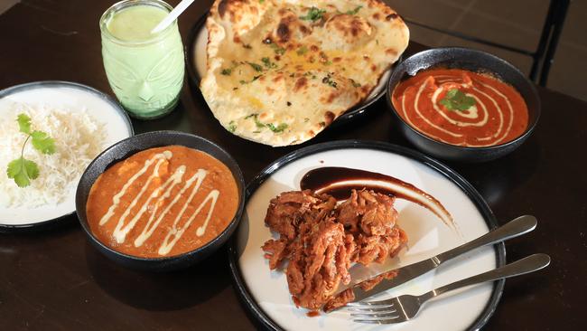 A smorgasbord selection of Indian curries, rice and naan bread at the new Spicy Bite restaurant at Smithfield Shopping Centre. Picture: Brendan Radke