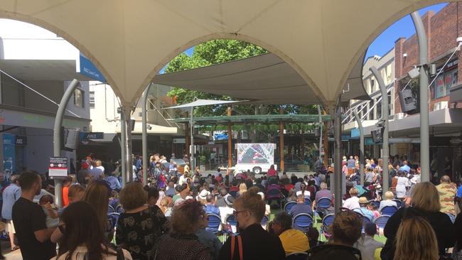 A photo of crowds watching the Melbourne Cup on the big screen at Lane Cove Plaza.