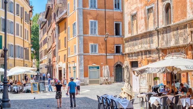 Diners and tourists on a street in Rome with numerous restaurants on a summer day. Picture: Istock