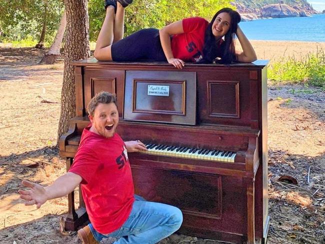 Star 106.3's Brady Ellis and Crystal Vas with the piano they delivered to Radical Bay, Magnetic Island in July. It has since been destroyed.