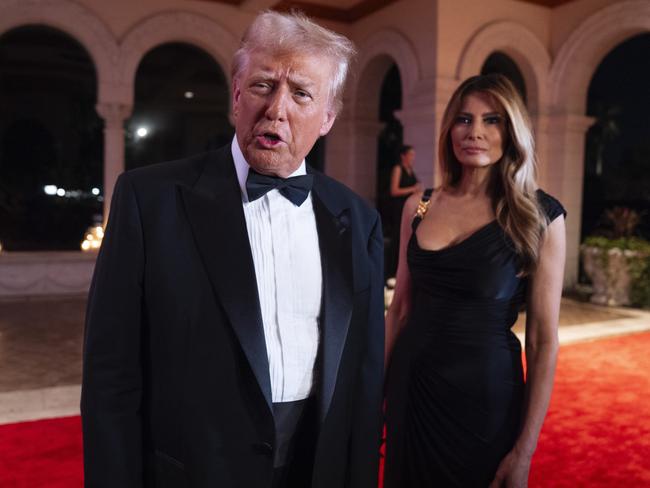 Melania Trump looks on as President-elect Donald Trump speaks to reporters before a New Year's Eve party at Mar-a-Lago, Tuesday, Dec. 31, 2024, in Palm Beach, Fla. (AP Photo/Evan Vucci)