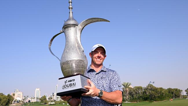 DUBAI, UNITED ARAB EMIRATES - JANUARY 30: Rory McIlroy of Northern Ireland celebrates with the winners trophy on the 18th green after the final round of the Hero Dubai Desert Classic at Emirates Golf Club on January 30, 2023 in Dubai, United Arab Emirates. (Photo by Ross Kinnaird/Getty Images)