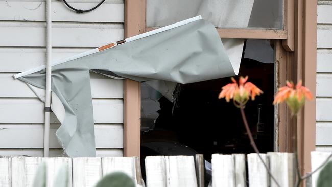 A smashed window at a house in Braybrook which was raided by police. Picture: Jay Town