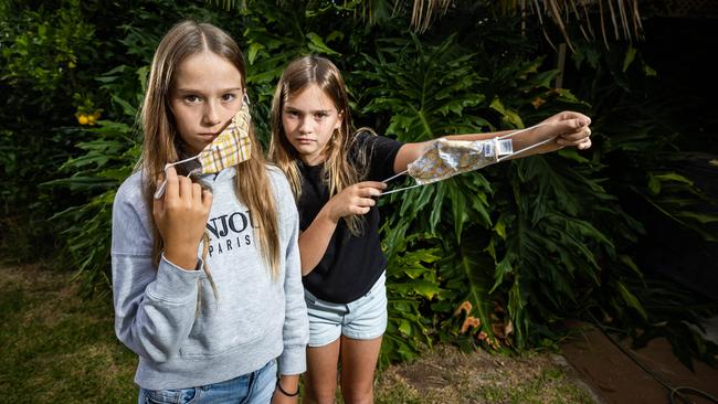 Sisters Ellie, 12, and Olivia, 9, react to news about masks staying at schools. Picture: Tom Huntley