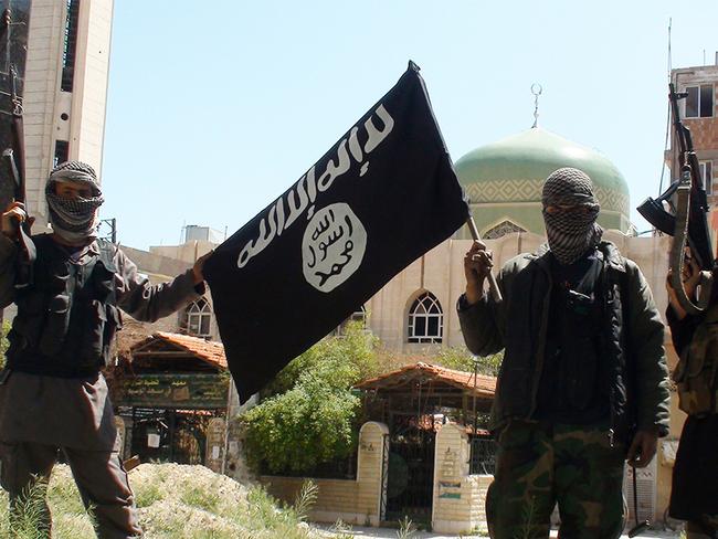 Islamic State militants posing in Yarmouk, a suburb of Damascus, Syria.