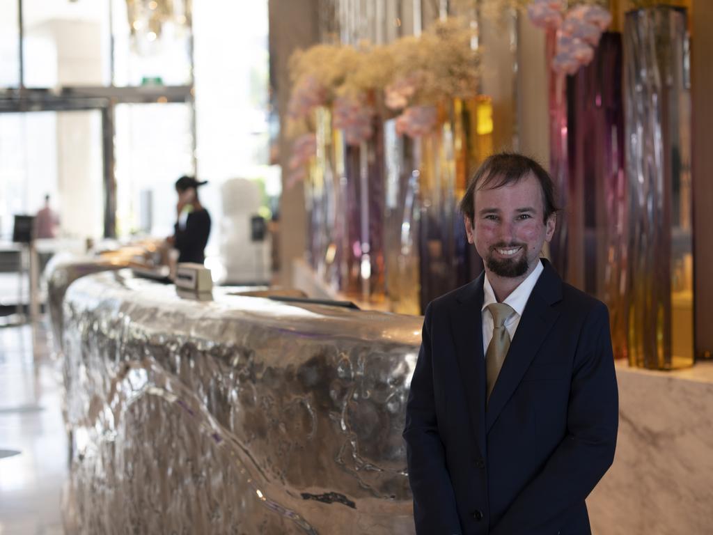 Robbie Logan lives with an acquired brain injury as a result of childhood cancer and works in a reception role at Crown Sydney. Picture: Ross Coffey