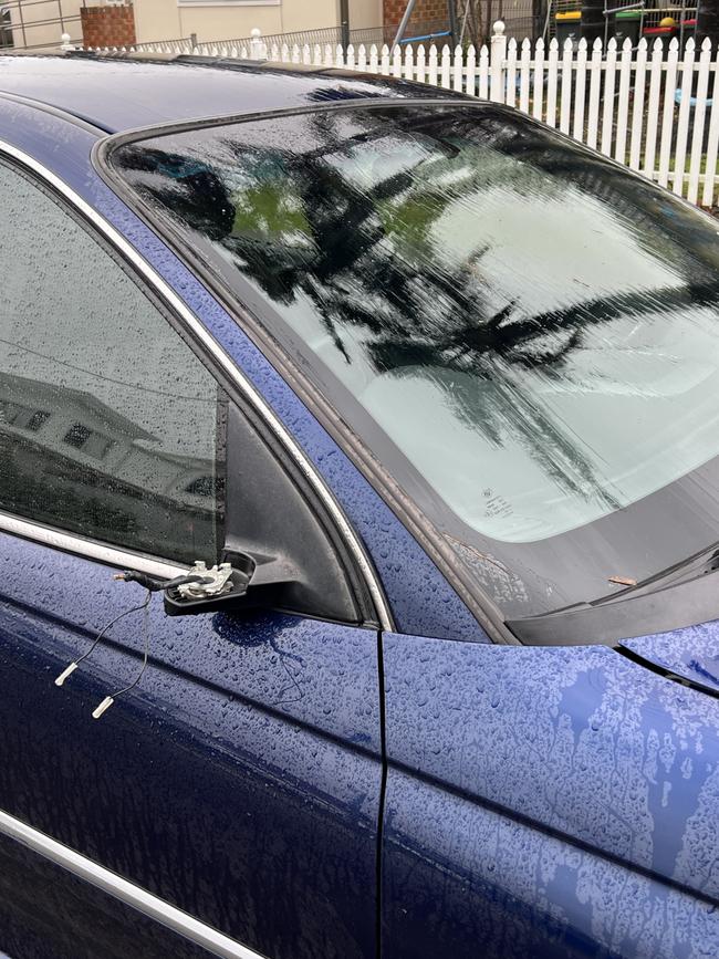 A car’s rear-vision mirror was struck off by a flying sheet of metal. Picture: Dylan Arvela