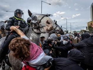 Anti-war activists protest the Land Forces 2024 International Land Defence Exposition at the Melbourne Convention and Exhibition Centre. Police mounted unit charges protesters at South Wharf. Picture: Jake Nowakowski