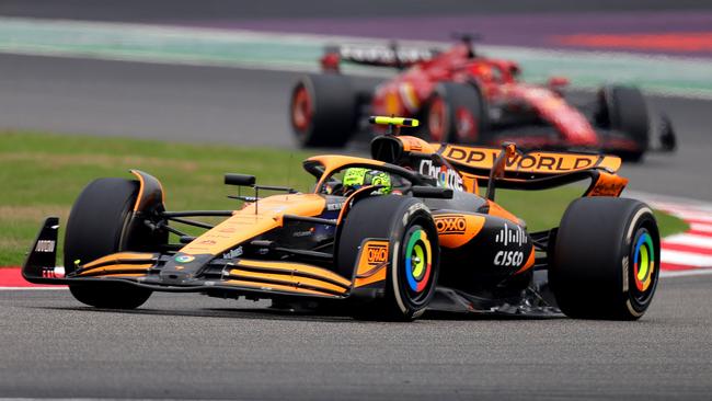 Lando Norris is splitting the two Red Bulls. (Photo by Lintao Zhang/Getty Images )