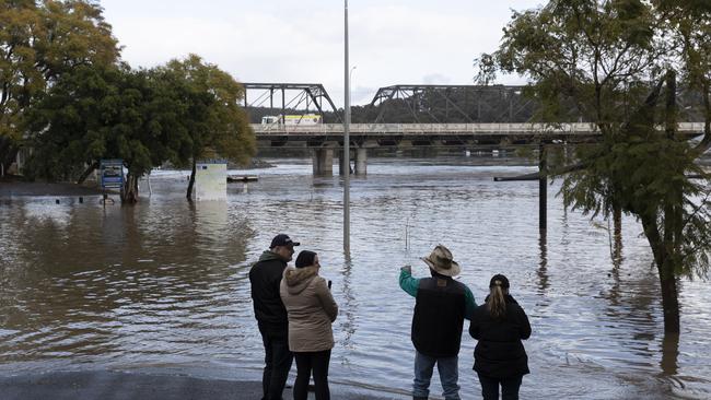 People look on as heavy flooding is seen along the Shoalhaven River in Nowra on Monday. Photo: Brook Mitchell/Getty Images.