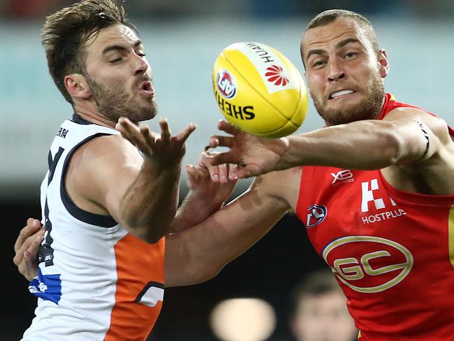 GOLD COAST, AUSTRALIA - AUGUST 24: Shane Mumford of the Giants and Jarrod Witts of the Suns compete for the ball during the round 23 AFL match between the Gold Coast Suns and the Greater Western Sydney Giants at Metricon Stadium on August 24, 2019 in Gold Coast, Australia. (Photo by Jono Searle/AFL Photos/via Getty Images)