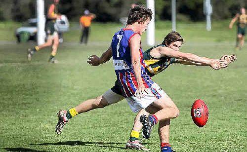 A Maroochy-Northshore defender tries to smother the kick of Wilston Grange’s Zac Molan earlier this season. Picture: Cade Mooney