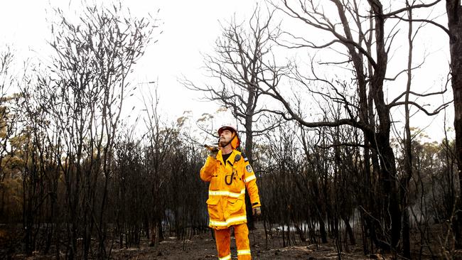 Thornton RFS firefighter Simon Rumble welcomes the rain. Picture: Peter Lorimer