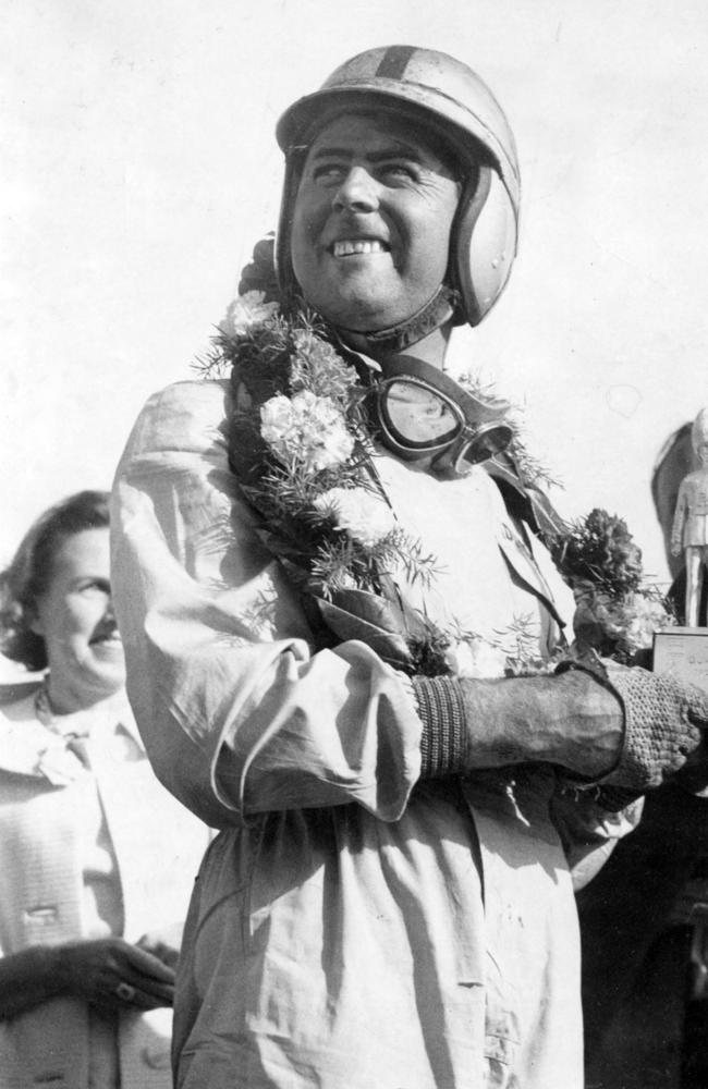 Jack Brabham holds the Guards Trophy after winning the event three race at Brands Hatch