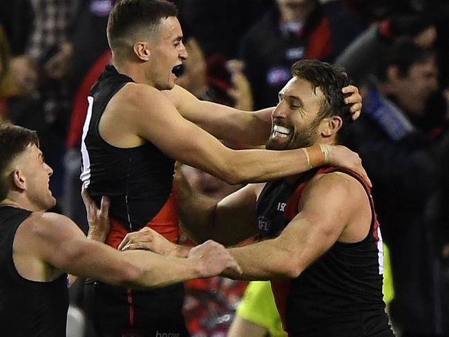 (L-R) Jayden Laverde, Orazio Fantasia and Cale Hooker of the Bombers react after Hooker kicked the winning goal during the Round 15 AFL match between the Essendon Bombers and the GWS Giants at Marvel Stadium in Melbourne, Thursday, June 27, 2019. (AAP Image/Julian Smith) NO ARCHIVING, EDITORIAL USE ONLY