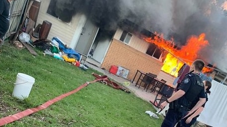 Police in the back yard of the Kingston house where fire broke out on Sunday.