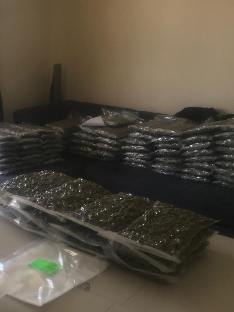 Bags of cannabis stacked up on lounges inside the house. Picture: AFP