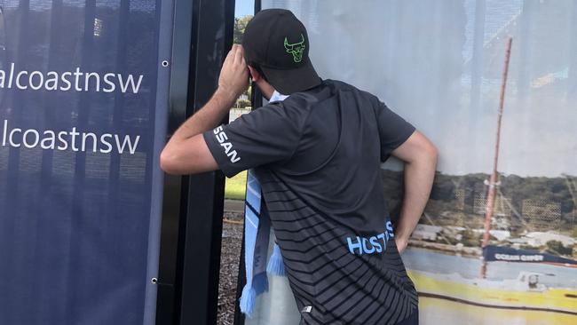 Melbourne City fan William Purssey watches his team in action from outside Central Coast Stadium in the first A-League game played behind closed doors. Picture: AAP