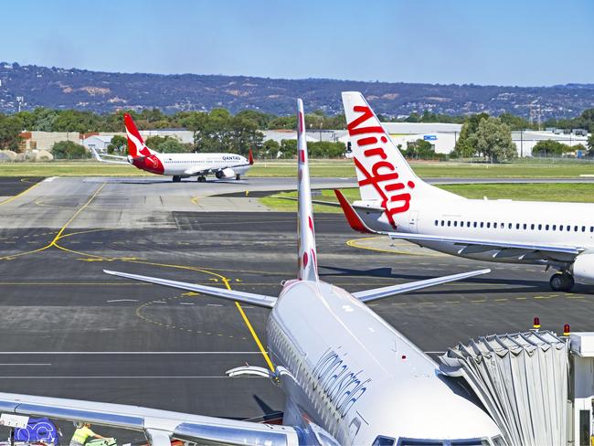 Planes from domestic air industry competitors and rivals Qantas and Virgin, coming and going. Picture: iStock