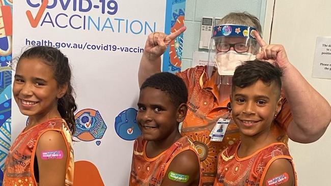 Ava Pensio, Alfred Motlop and Maia Pensio here with immunisation nurse Jan Lile, were among the children vaccinated at the Torres and Cape Hospital and Health Service vaccination clinic at the Lions Hall in Cooktown.