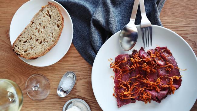 Kangaroo pastrami served with cultured cream and crunchy shallots is a taste-texture triumph. Picture: Rebecca Michael