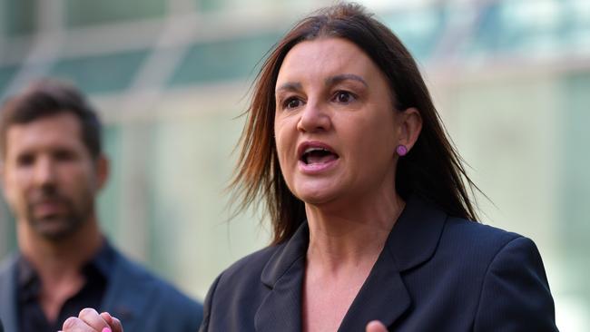 CANBERRA, AUSTRALIA - DECEMBER 08: Former Special Air Service Regiment soldier Heston Russell (left) listens as Senator Jacqui Lambie addresses media in the Senate Courtyard at Parliament House on December 08, 2020 in Canberra (Photo by Sam Mooy/Getty Images)