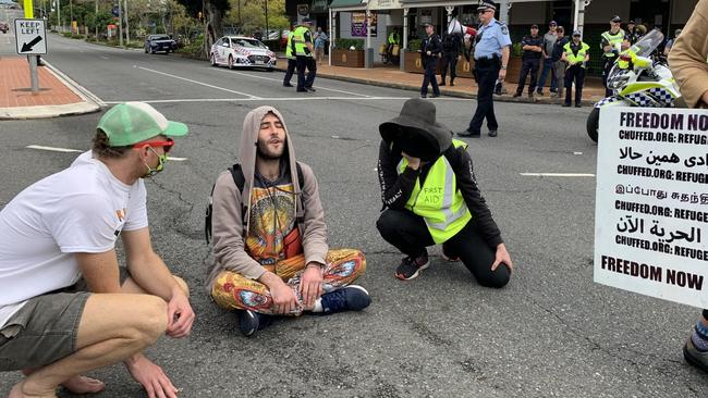 A protester sits in Main St, Kangaroo Point. Picture: Patrick Billings