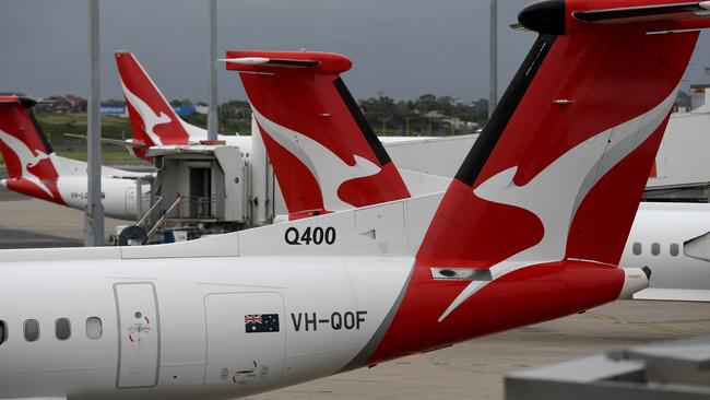 SYDNEY, AUSTRALIA - NCA NewsWire Photos DECEMBER, 31, 2020: The tails of grounded Qantas planes are seen on the tarmac at Sydney Domestic Airport. Victoria has announced a hard border closure with NSW from 11:59pm on January 1, whilst SA will reimpose its hard border closure with NSW from midnight January 1, following 10 new COVID-19 cases in NSW today. Picture: NCA NewsWire/Bianca De Marchi