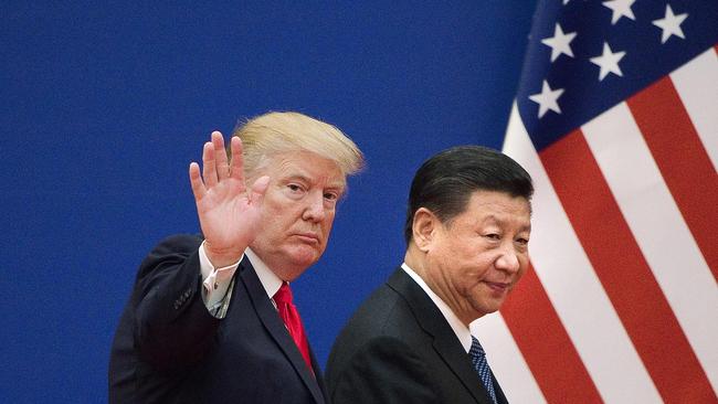 (FILES) In this file photo taken on November 9, 2017 shows US President Donald Trump (L) and China's President Xi Jinping leaving a business leaders event at the Great Hall of the People in Beijing. - President Donald Trump on September 18, 2018 accused China of seeking to influence upcoming US elections by taking aim at his political support base in the countries' escalating trade war. "China has openly stated that they are actively trying to impact and change our election by attacking our farmers, ranchers and industrial workers because of their loyalty to me," Trump tweeted.Trump's comments came a day after he targeted another $200 billion in Chinese imports with tariffs starting next week, drawing an immediate vow of retaliation from Beijing. (Photo by Nicolas ASFOURI / AFP)