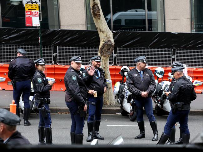 The Australian Police force wait to escort the US Vice President Mike Pence's motorcade as it leaves the Intercontinental Hotel in Sydney.